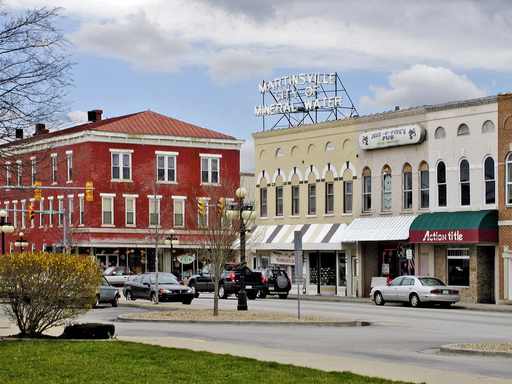 Charming small-town street with historic and modern architecture, greenery, and a relaxed vibe, evoking community and nostalgia.