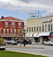Charming small-town street with historic and modern architecture, greenery, and a relaxed vibe, evoking community and nostalgia.