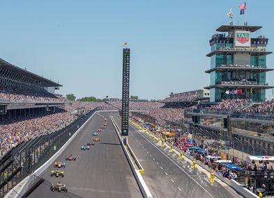Vibrant motorsport event with speeding cars, excited crowd, and a professional backdrop, capturing the thrill and energy.