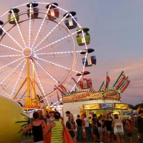 A vibrant carnival scene featuring a colorful Ferris wheel, lively stalls, and joyful crowds evokes happiness and nostalgia.