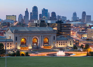 Vibrant city skyline at dusk, mixing modern buildings with historical structures, greenery, and a serene atmosphere.
