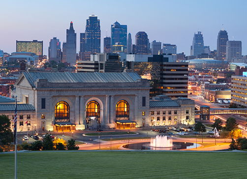 Vibrant city skyline at dusk, mixing modern buildings with historical structures, greenery, and a serene atmosphere.