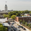 Charming town with a historic clock tower, vibrant community, greenery, and inviting streets that evoke nostalgia and comfort.