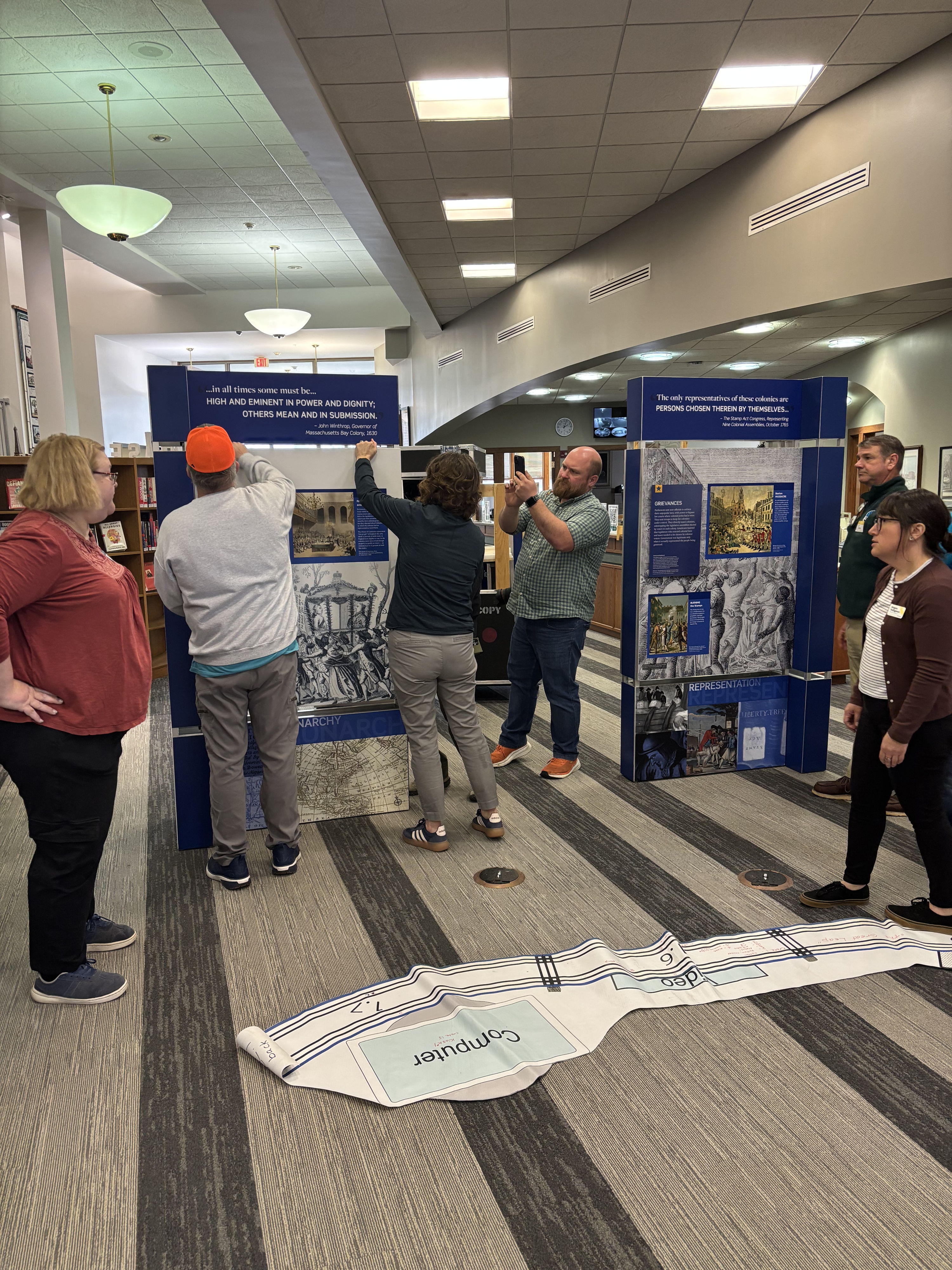 Lively exhibition scene with engaged individuals, displays, and a community atmosphere reflecting curiosity and connection.