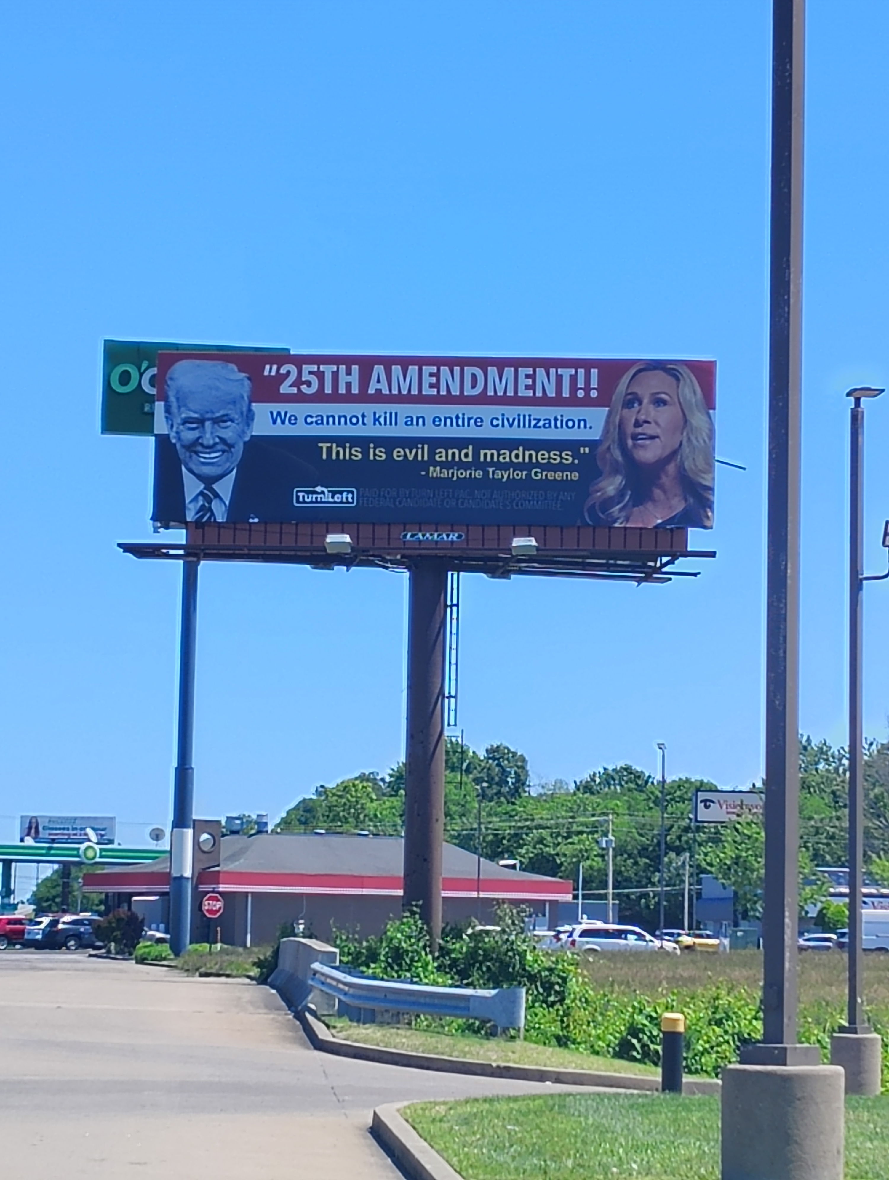 Billboard features bold "25th Amendment" text and images of political figures, invoking strong emotions about current issues.