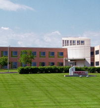 Modern building with brick and glass in a green landscape, evoking tranquility, professionalism, and positivity.