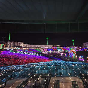 A vibrant display of colorful lights in a festive outdoor setting, evoking joy and nostalgia in a magical night atmosphere.