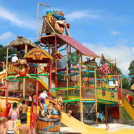 A vibrant water park with colorful slides and whimsical designs, filled with families enjoying a joyful summer day.