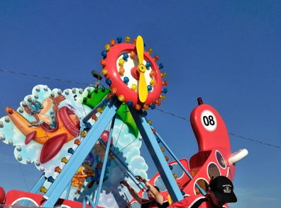 Colorful amusement ride for children with playful designs, evoking excitement and joy; a lively, inviting atmosphere.