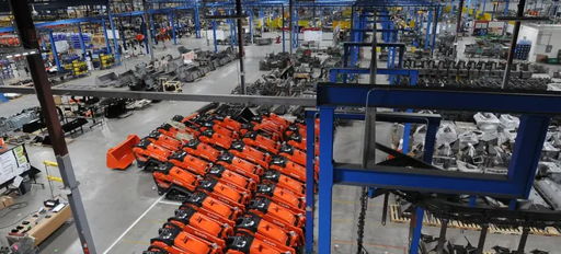 Industrial warehouse with organized orange machines, showcasing a bustling, efficient, and productive environment.