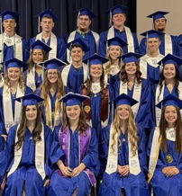 Graduation ceremony with students in blue gowns, smiling in unity, expressing pride, joy, and hope for the future.