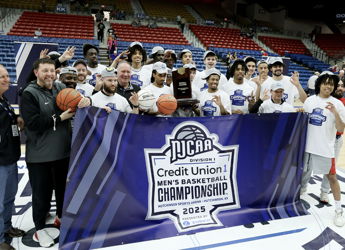Basketball team celebrates NJCAA Championship victory with joy, holding a trophy and basketballs, showcasing teamwork and pride.