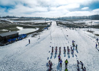 Snowy landscape with athletes preparing for winter sports, evoking excitement, serenity, adventure, and community.