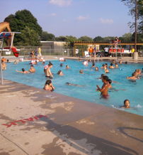 A vibrant pool scene with joyful people swimming and playing, capturing summer fun and community on a sunny day.