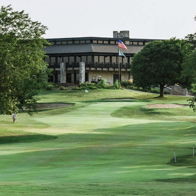 A tranquil golf course with lush fairways, a modern clubhouse, and inviting greenery exuding calmness and leisure.