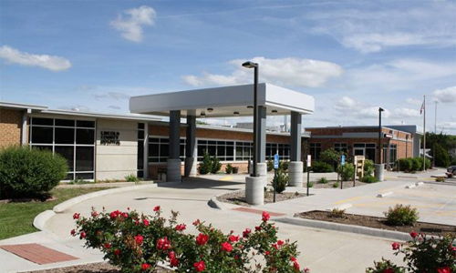 Modern building in a landscaped setting with vibrant roses, exuding warmth, serenity, and a sense of community.