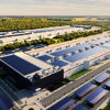 Industrial facility with solar panels, organized layout, and greenery, symbolizing progress, efficiency, and harmony with nature.