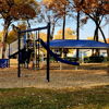 Lively park scene with people exercising among autumn trees, fostering community and energy in a vibrant setting.