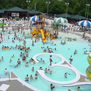 A lively water park scene with joyful crowds enjoying slides, pools, and summer fun under colorful umbrellas.