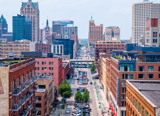 Vibrant urban landscape with brownstones, modern skyscrapers, and lively street, evoking energy and a sense of community.