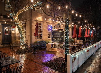 Cozy inn at night with warm string lights, rustic charm, outdoor seating, and a tranquil atmosphere. Perfect for relaxation.