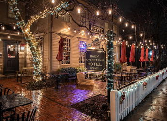 Cozy inn at night with warm string lights, rustic charm, outdoor seating, and a tranquil atmosphere. Perfect for relaxation.