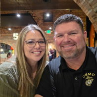 A happy couple poses for a selfie in a cozy, rustic setting, conveying warmth, joy, and a sense of togetherness.