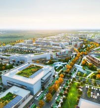 Aerial view of a modern, eco-friendly architectural complex amidst greenery, conveying tranquility and optimism in urban living.
