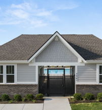 Charming modern building with a sloped roof, pool area, and manicured landscaping, evoking a welcoming and serene atmosphere.