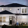 A modern two-story house with white siding, stone accents, and a tranquil twilight setting evokes comfort and hope.