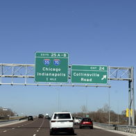 Highway sign shows directions to Chicago and Indianapolis on a clear day, evoking adventure, freedom, and anticipation.