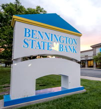Bennington State Bank features a colorful, modern design surrounded by greenery, evoking stability, trust, and a welcoming atmosphere.