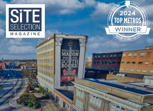 Cityscape of Macon featuring "WELCOME TO MACON" mural, bright sky, and "2024 TOP METROS WINNER" badge, exuding vibrancy and pride.