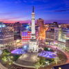 Twilight cityscape with a landmark monument, illuminated buildings, and a colorful sky, capturing urban vibrancy and tranquility.