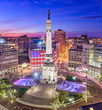 Twilight cityscape with a landmark monument, illuminated buildings, and a colorful sky, capturing urban vibrancy and tranquility.