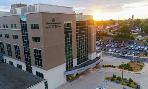 Modern medical facility at sunset, featuring glass windows and a welcoming entrance, evokes hope and tranquility.