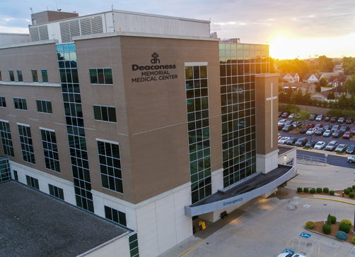 Modern medical facility at sunset, featuring glass windows and a welcoming entrance, evokes hope and tranquility.