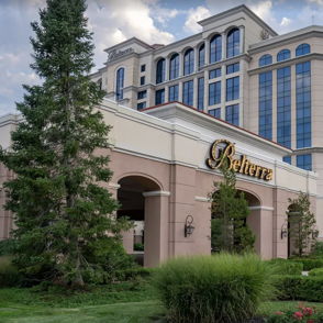 Modern resort building with elegant architecture, lush landscaping, and a tranquil sky, evoking luxury and relaxation.