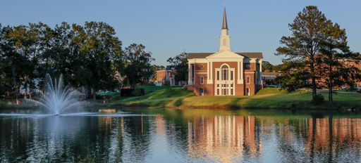 A peaceful landscape with a church by a calm lake, surrounded by greenery and soft sunlight, evoking serenity and spirituality.