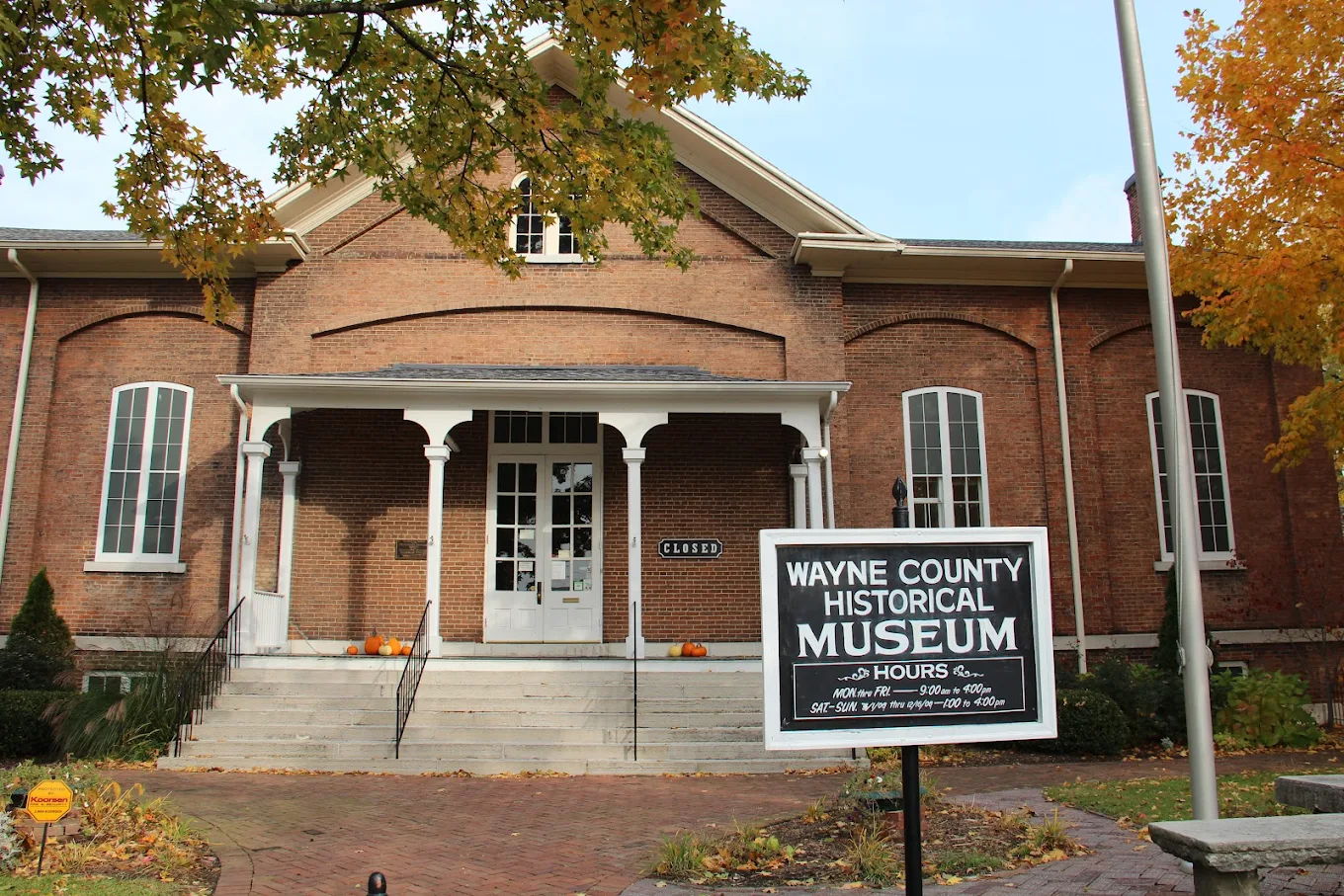 Historic Wayne County Historical Museum with classic brick façade, autumn trees, and a welcoming entrance.
