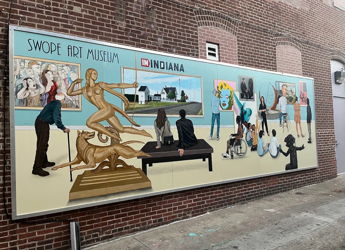 Vibrant mural at Swope Art Museum shows figures engaging with art, evoking inspiration, joy, and appreciation for creativity.