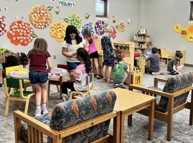 Engaged children playing with toys in a colorful classroom, overseen by a nurturing adult, radiating joy and curiosity.