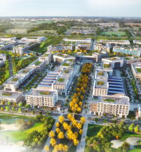 Aerial view of a modern urban development with green spaces, organized buildings, and community-friendly pathways.
