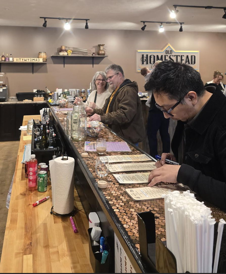 Lively bar scene with patrons socializing in a cozy, well-lit atmosphere, evoking warmth and camaraderie.