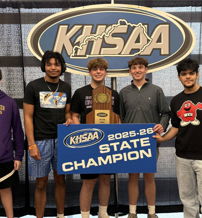 Group of five young people celebrating a sports victory with a trophy and "STATE CHAMPION" sign in front of a KHSAA backdrop.