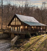 Cozy cabin in woods, a-frame design with glowing windows, warm atmosphere, and serene nature setting evoke tranquility.