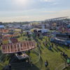 A vibrant fair scene with colorful rides, game booths, and food vendors, radiating joy, community, and a festive atmosphere.