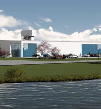 Modern building by a tranquil lake, featuring glass windows, surrounded by greenery, evoking tranquility and harmony.
