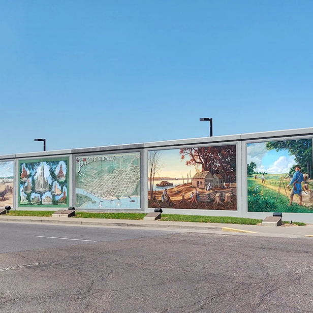 Large murals depict vibrant historical and cultural scenes, evoking joy, nostalgia, and a connection to community and nature.