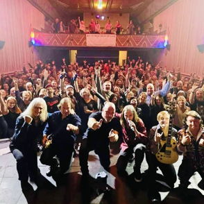 A vibrant concert scene with a joyful band and an enthusiastic, engaged audience, capturing the energy of live music.